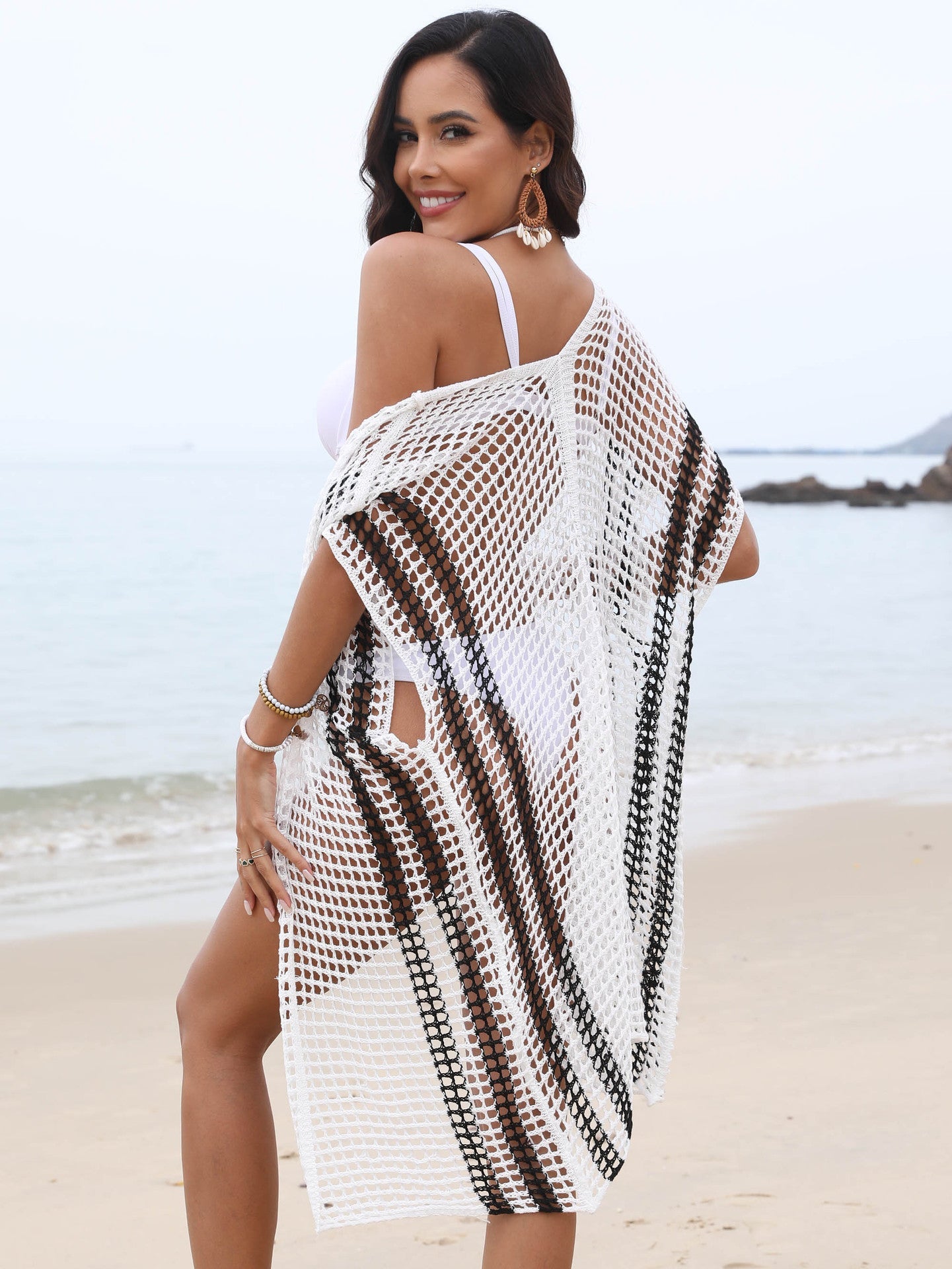 Women's crochet beach cover-up in boho style with airy sleeves and frayed accents