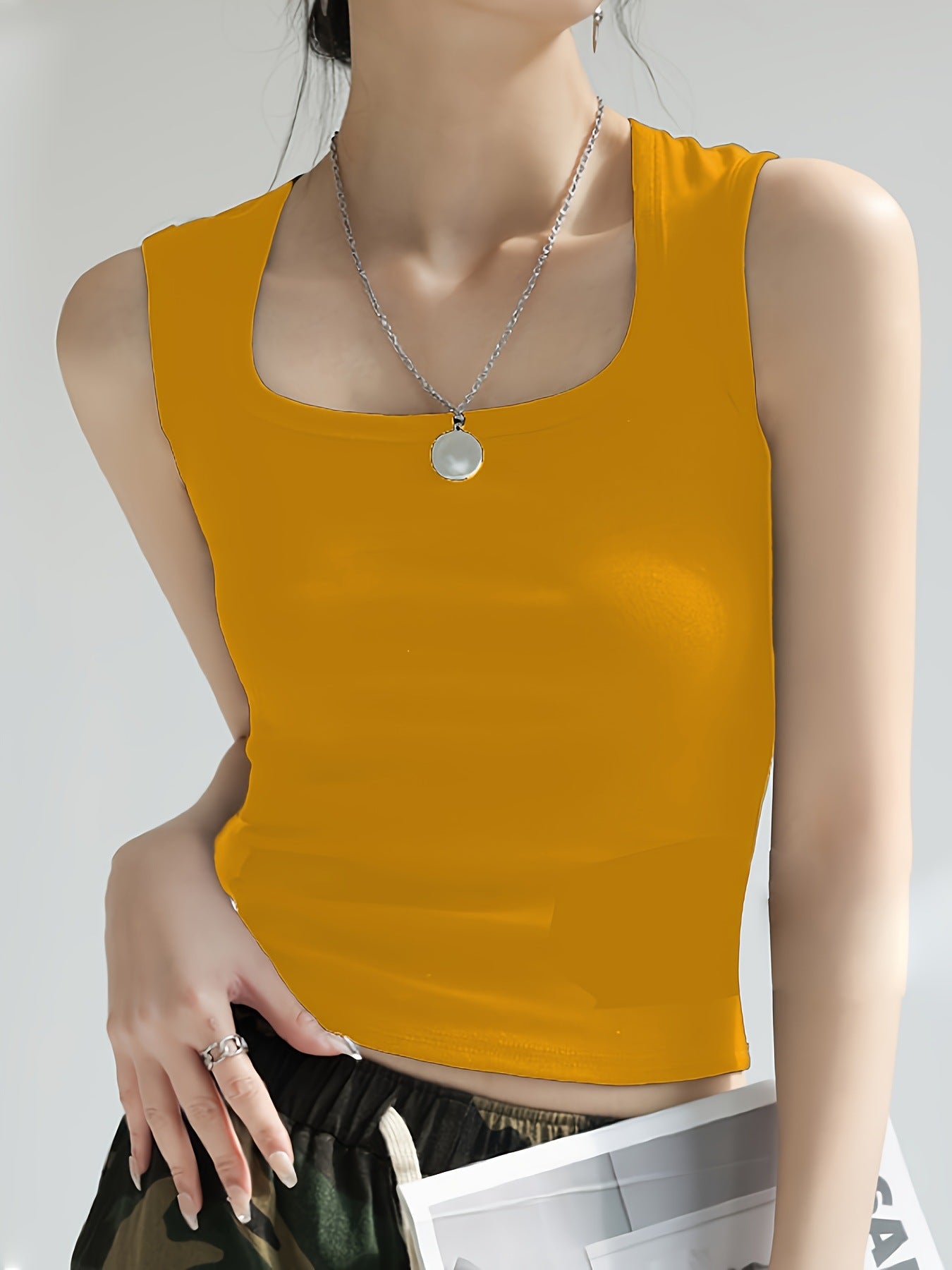 Women's sleeveless crop top made of elastic material with a figure-shaping cut WW