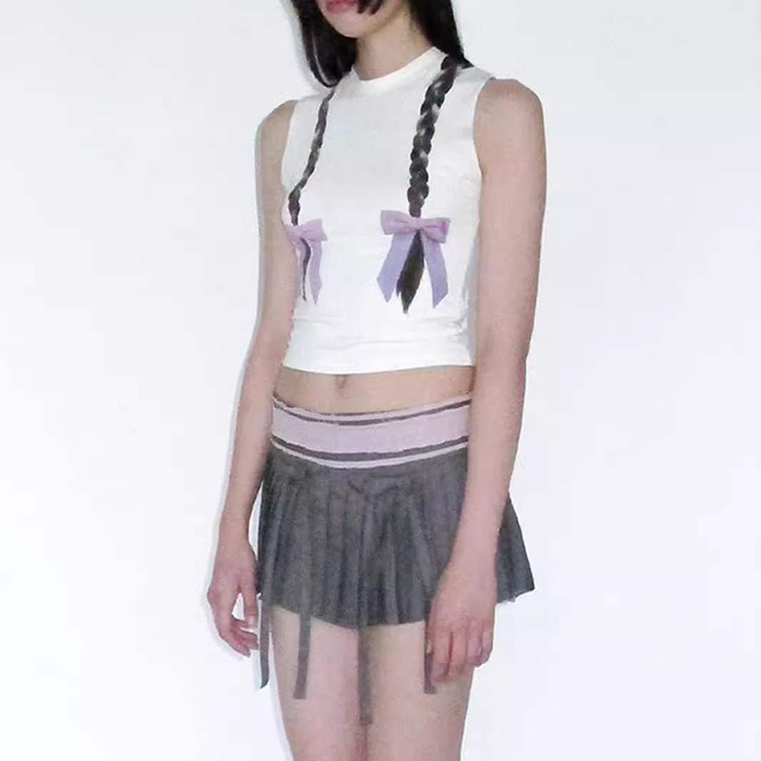 Women's sleeveless top with playful cable design and bow accents W&W
