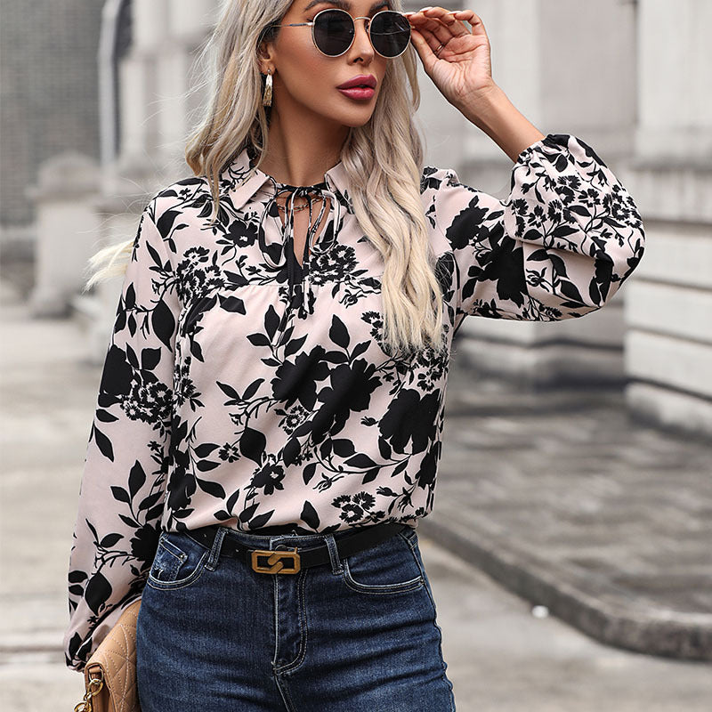 Women's blouse with elegant ruffle details and playful floral pattern WW