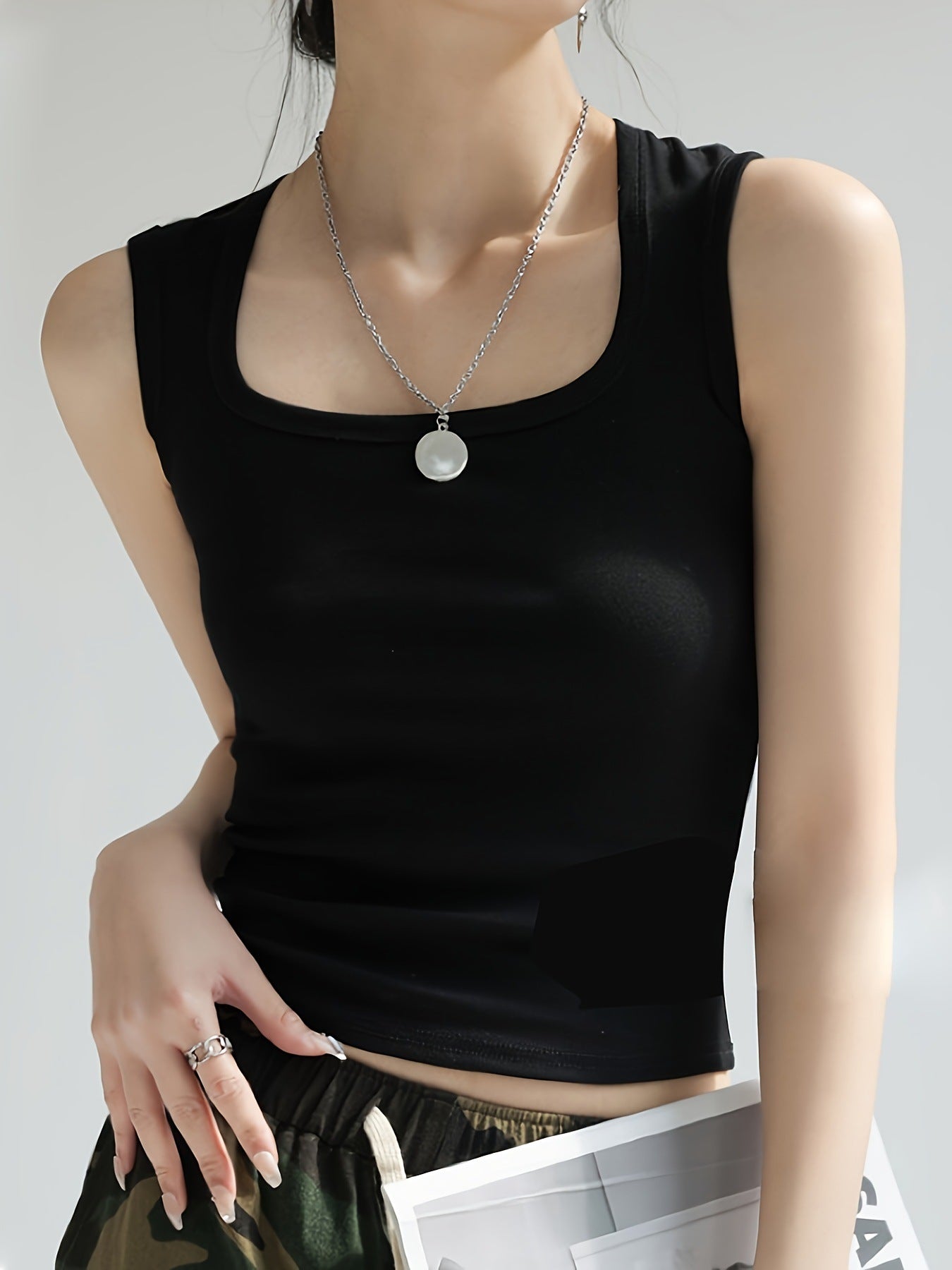 Women's sleeveless crop top made of elastic material with a figure-shaping cut WW