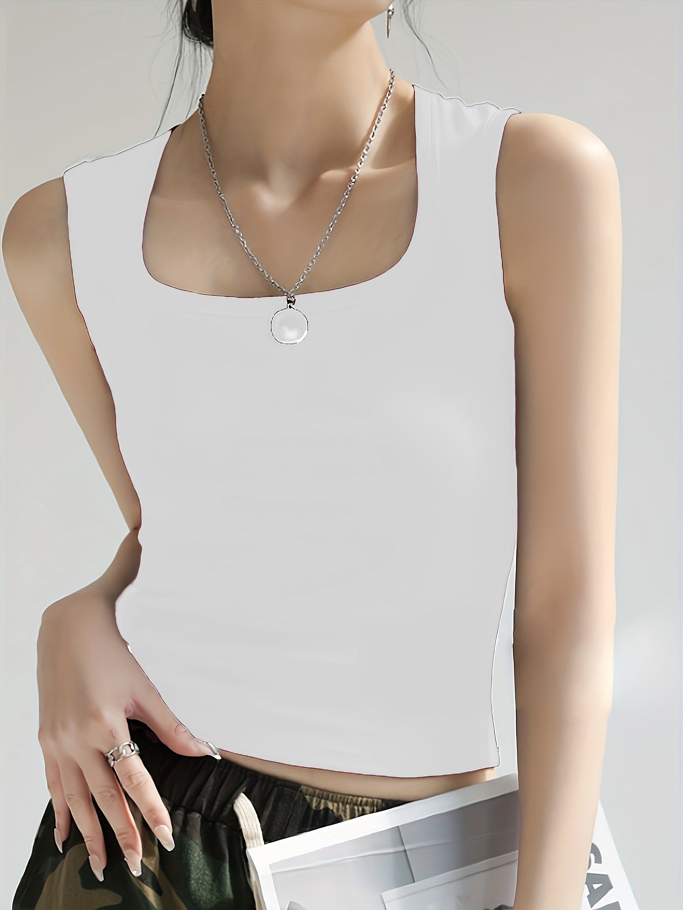 Women's sleeveless crop top made of elastic material with a figure-shaping cut WW