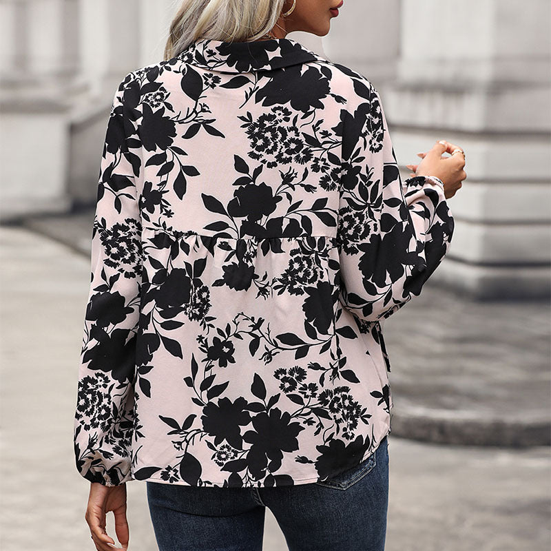 Women's blouse with elegant ruffle details and playful floral pattern WW