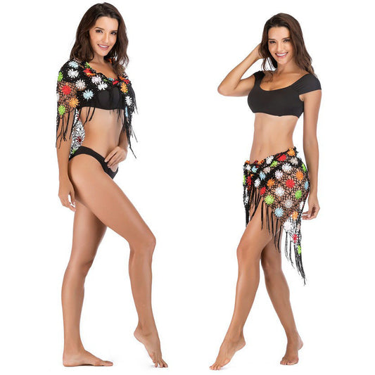 Women's crocheted beach cover-up with colorful floral details and fringes