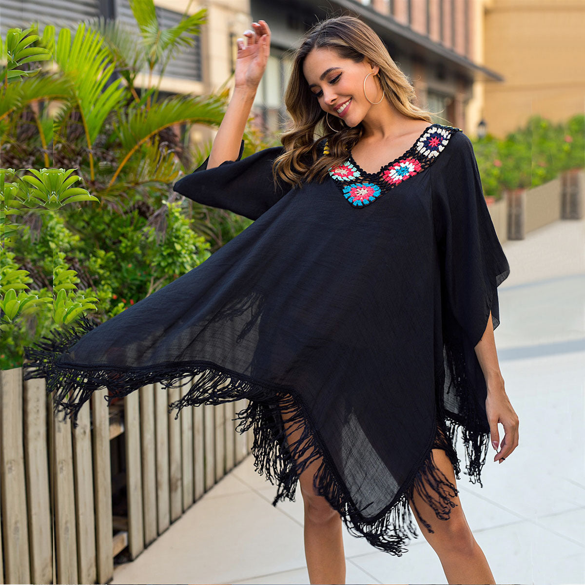 Women's beach poncho with artistic fringes and colorful appliqués