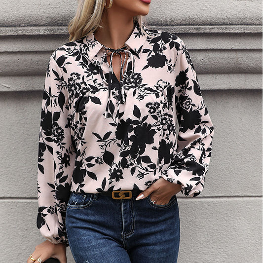 Women's blouse with elegant ruffle details and playful floral pattern WW