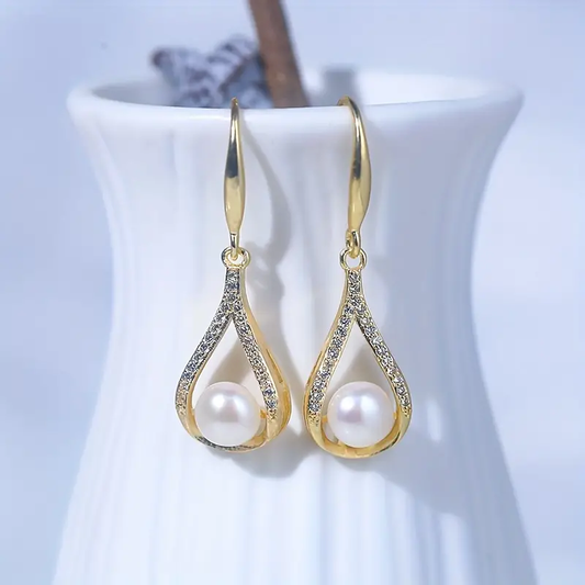 White pearl earrings with diamonds in gold